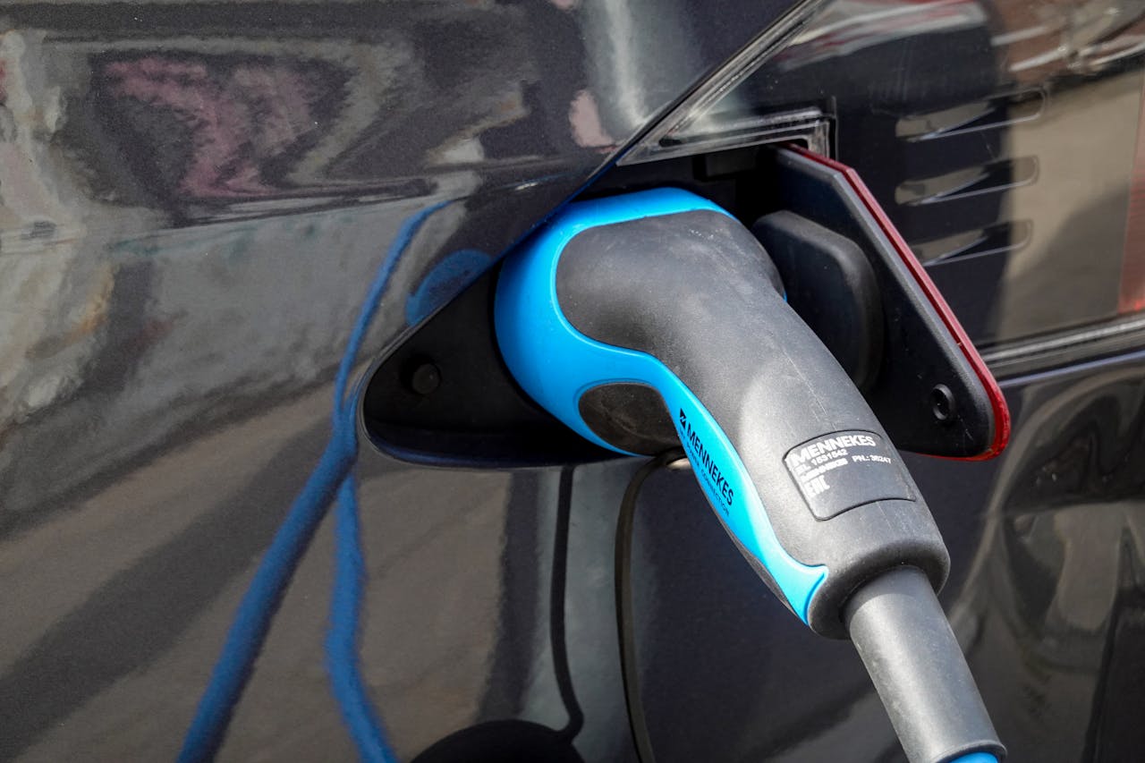 gallery-2 Close-up of an electric vehicle being charged using a Mennekes EV connector.