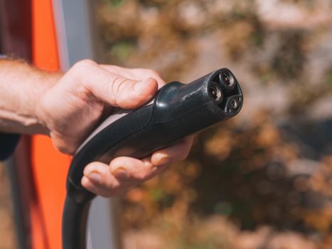 pexels photo 9799736 9799736 Hand holding an electric vehicle charging plug, symbolizing clean energy and innovation.